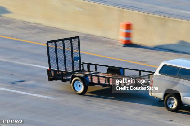 utility trailer being pulled by a pickup truck - utility trailer stock pictures, royalty-free photos & images