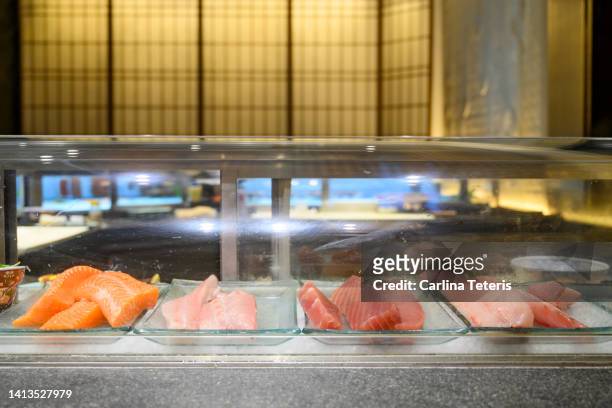 fish on display in a sushi restaurant - sushi bar stock pictures, royalty-free photos & images