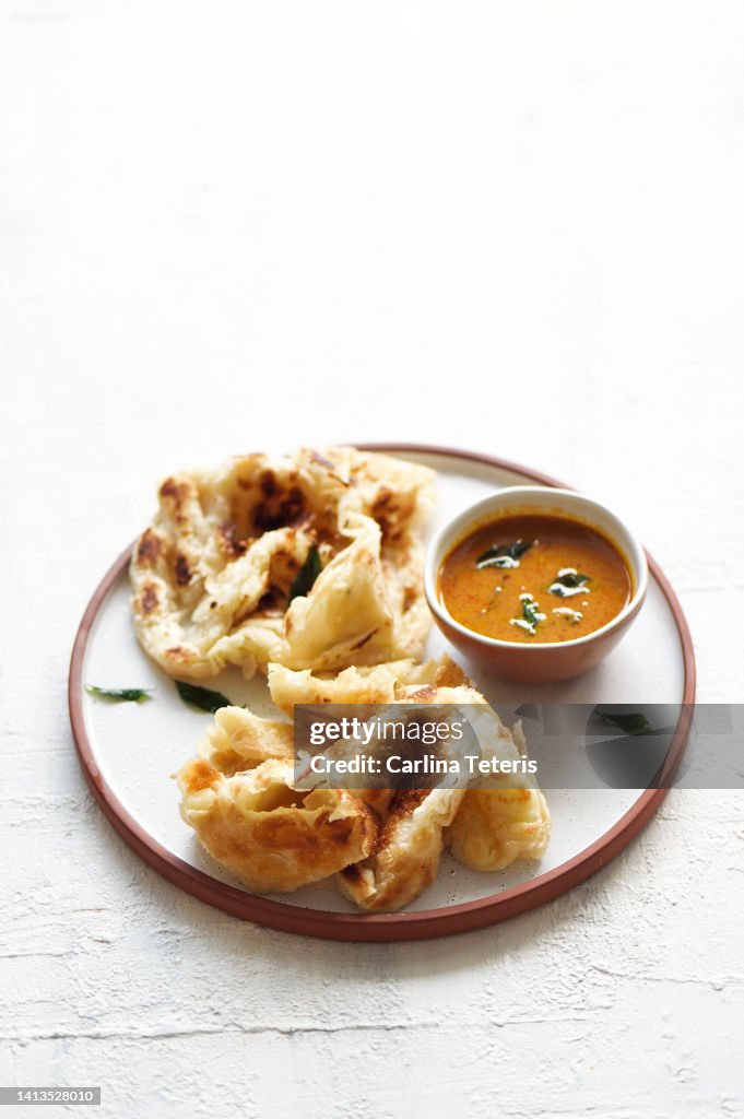 Roti prata with fish curry