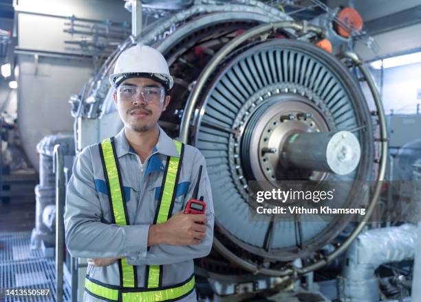 male asian engineer working with gas turbine at power plant industrial. - district heating plant stock-fotos und bilder