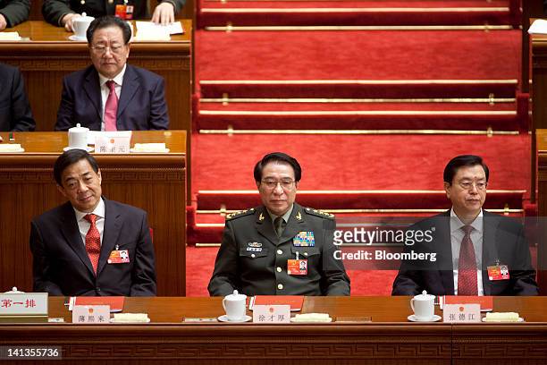 Bo Xilai, then Chinese Communist Party secretary of Chongqing, left, Xu Caihou, vice chairman of China's Central Military Commission, center, and...