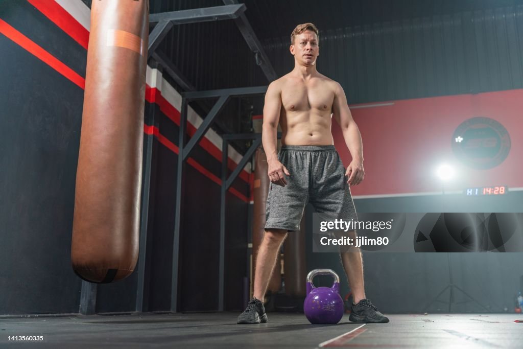 Young And Handsome Male Boxer With Muscular Build Body Doing Dumbbell