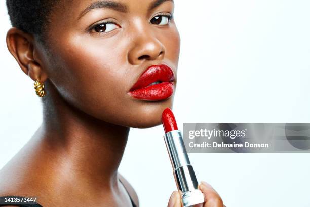 beautiful african american model with red lips and gorgeous skin, posing and looking into camera. advertising skincare and cosmetics for ethnic women. showing the latest shade of a popular lipstick - eye make up bildbanksfoton och bilder