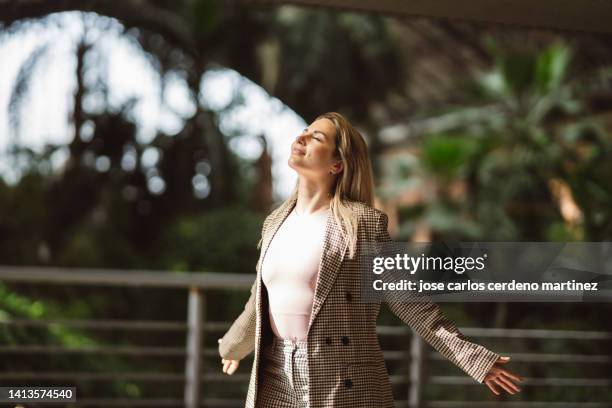 business woman leaving work feeling free raises her arms and breathes - breathing new life stock pictures, royalty-free photos & images