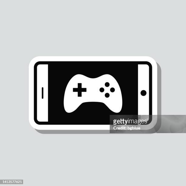 stockillustraties, clipart, cartoons en iconen met video game on smartphone. icon sticker on gray background - game console
