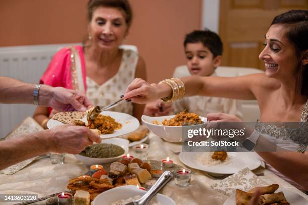 try my curry - diwali family stock pictures, royalty-free photos & images