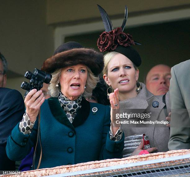 Camilla, Duchess of Cornwall and Zara Phillips watch the 'Queen Mother Champion Steeple Chase' horse race on day 2 'Ladies Day' of the Cheltenham...