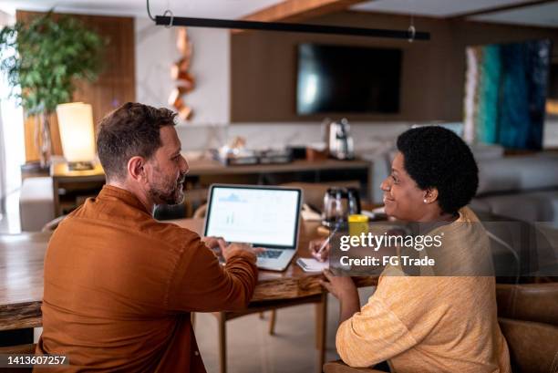 mature couple using laptop doing home finances - annotation stock pictures, royalty-free photos & images