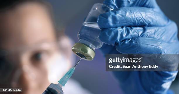 medical, healthcare and science professional with bottle, needle and vaccine cure for marburg virus, ebola and monkeypox. closeup of biologist, scientist or pathologist ready to inject medicine - coronavirus africa stock pictures, royalty-free photos & images