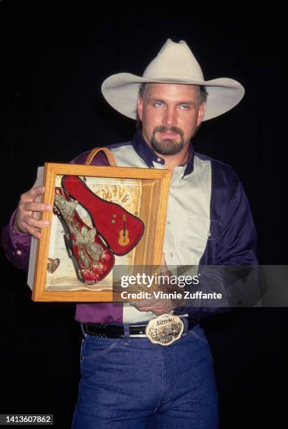 Garth Brooks holds up award at the 1st Annual VH1 Honors Artists and Their Causes at Shrine Auditorium in Los Angeles, California, United States,...