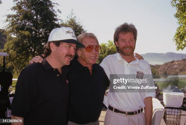 Kix Brooks, Buck Owens and Ronnie Dunn in golfing attire pose together, United States, circa 1994.