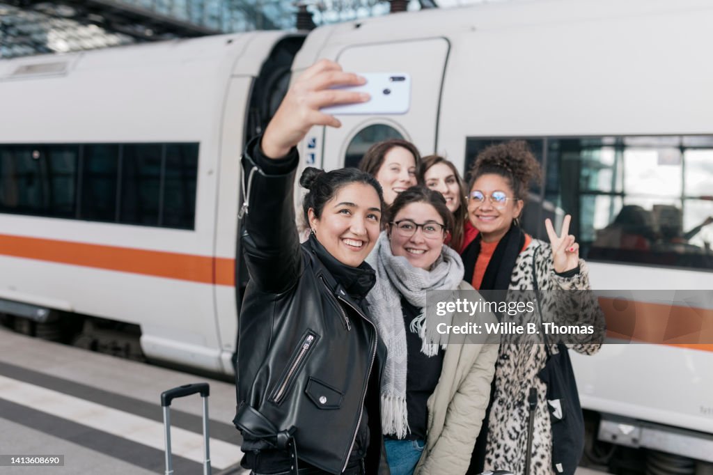 Friends Taking Selfie In Front Of Train Together