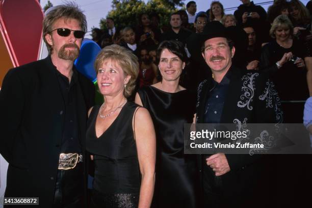 Ronnie Dunn beside wife Janine Dunn and Kix Brooks alongside his wife Barbara Brooks, attend the 25th Anniversary Arista Records Show taping held at...
