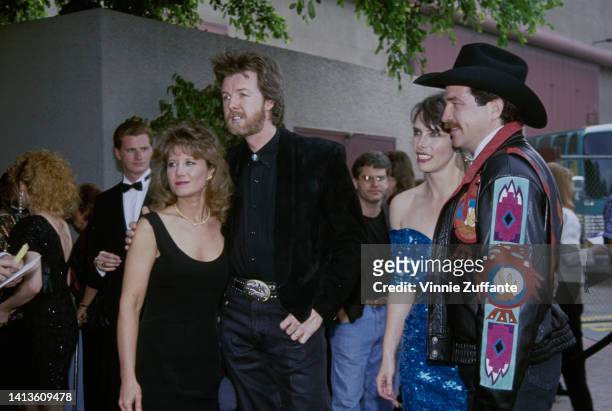 Ronnie Dunn and Kix Brooks pose with each of their wives -Janine Dunn and Barbara Brooks at the 27th Academy of Country Music Awards, held at the...