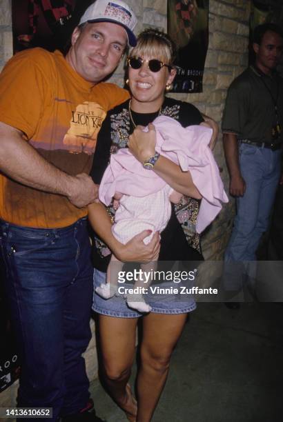 Garth Brook beside his wife Sandy Mahl holding their infant daughter 'August', at his concert held at the Hollywood Bowl in Los Angeles, California,...