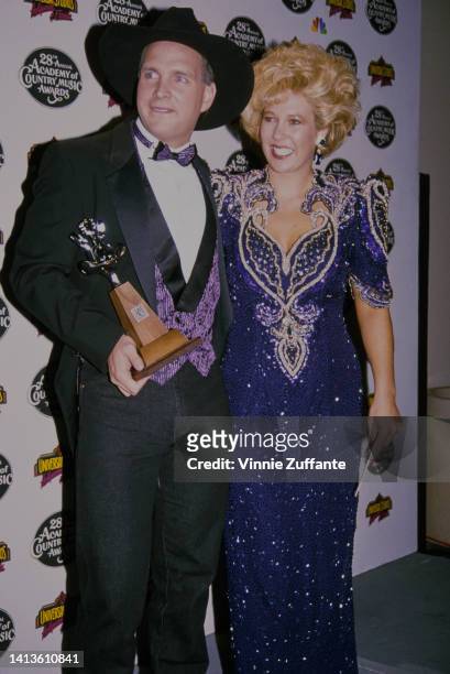 Garth Brooks holding his award poses with wife Sandy Mahl at the 28th Academy of Country Music Awards held at the Universal Amphitheatre in Los...