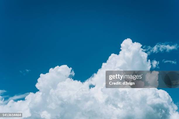 white clouds in blue sky on a sunny summer day - nur himmel stock-fotos und bilder