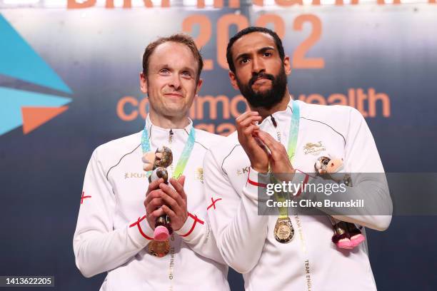 Gold Medallist James Willstrop and Declan James of Team England celebrate during the Squash Men's Doubles Medal Ceremony on day eleven of the...