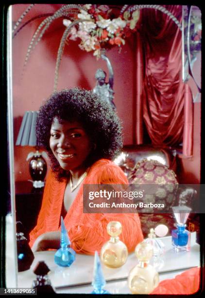 Portrait of American Disco and R&B singer Gloria Gaynor as she poses, reflected in a mirror, 1981.