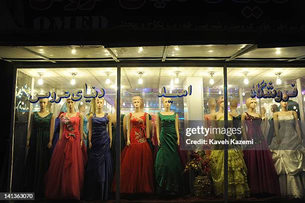 Womens dresses tailored by Afghani tailors are displayed on mannequins in a shop window on October 16, 2011 in Kabul, Afghanistan.