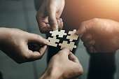 mobile jigsaw puzzle pieces business cooperation concept teamwork and cooperation Businessmen join a jigsaw team, charity, volunteerism, unity, teamwork.