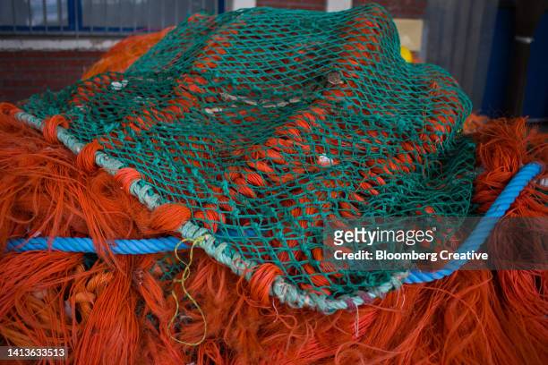 fishing nets at a harbour - creative fishing stock-fotos und bilder