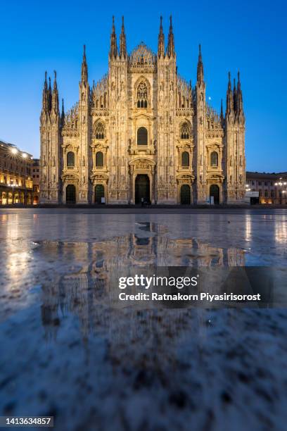 sunrise scene of the ornate gothic facade, soaring spires and magnificent marble towers of the duomo, milan's monumental cathedral under big blue lombardy skies - marble cathedral stock pictures, royalty-free photos & images