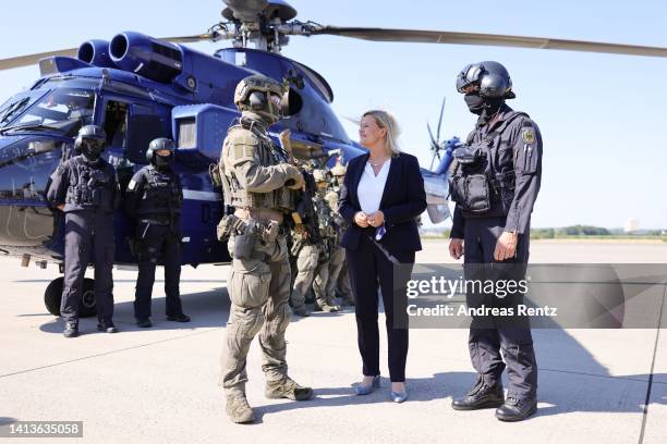 German Interior Minister Nancy Faeser talks with members of the GSG 9 federal police special forces unit during a visit to their training center on...