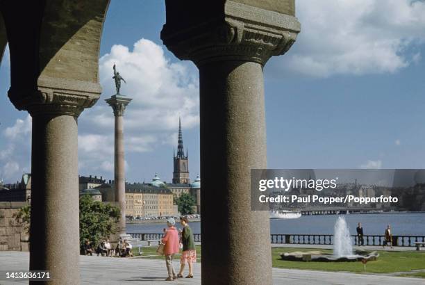 Visitors walk through Stadshusparken City Hall gardens on Kungsholmen island in central Stockholm, capital city of Sweden circa 1960. In the...