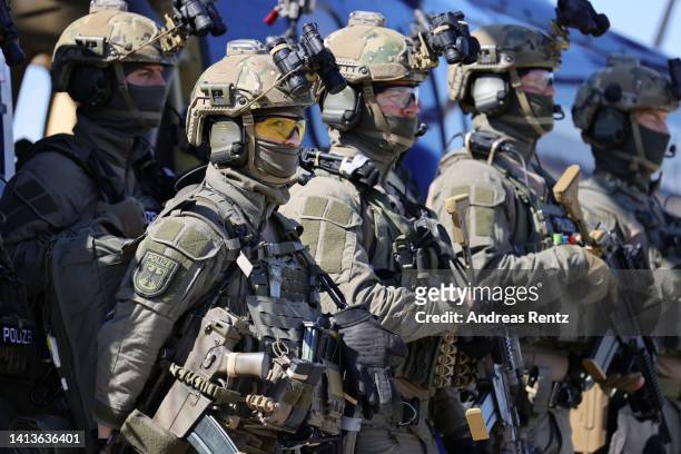 Members of the GSG 9 federal police special forces unit stand next to a Bundespolizei helicopter during a visit of German Interior Minister Nancy...