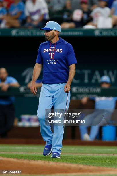 Chris Woodward of the Texas Rangers walks to the mound in the fourth inning against the Chicago White Sox at Globe Life Field on August 07, 2022 in...