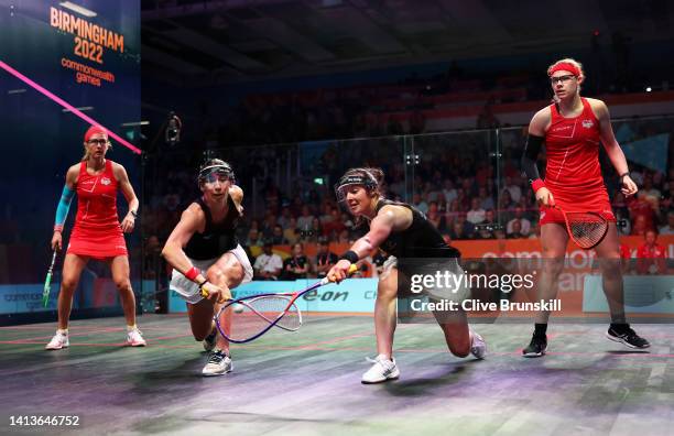 Joelle King and Amanda Landers-Murphy of Team New Zealand compete with Sarah-Jane Perry and Alison Waters of Team England during the Squash Women's...