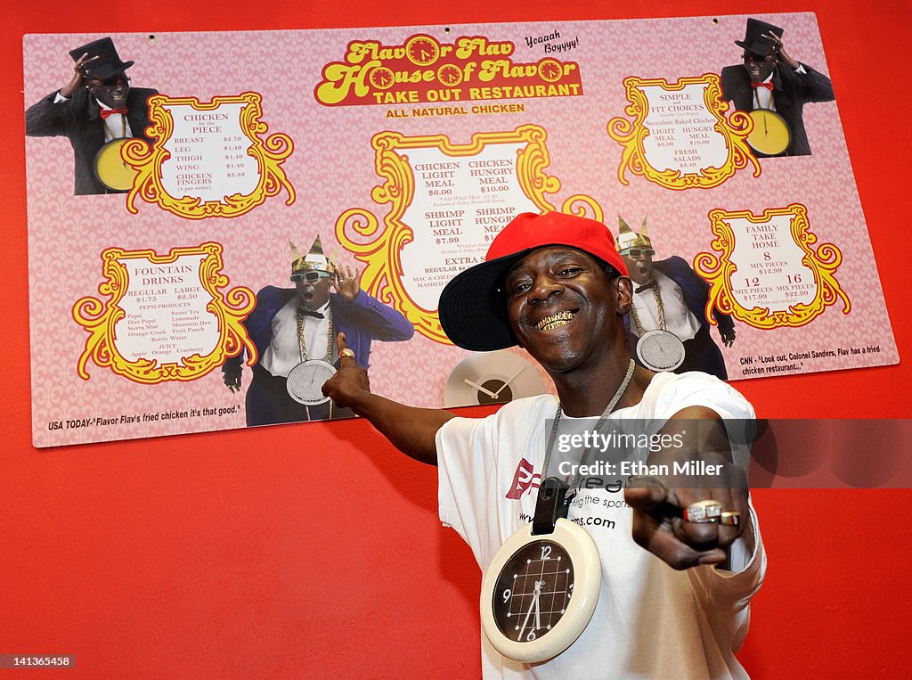 Java Flav Rapper Flavor Flav poses in front of a menu on the wall of his Flavor ...