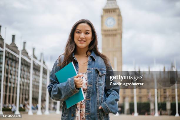 happy asian female student in london - international students stock pictures, royalty-free photos & images