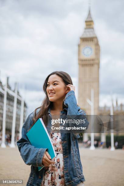 happy asian female student in london - happy students stockfoto's en -beelden