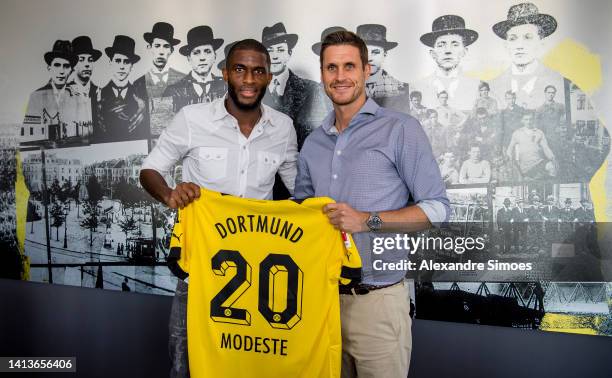 Newly signed player of Borussia Dortmund Anthony Modeste and Sebastian Kehl, sporting director of Borussia Dortmund, pose on August 08, 2022 in...