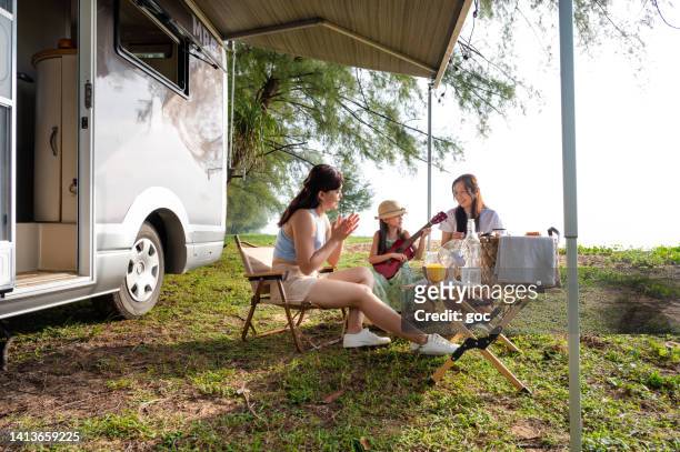 young asian family enjoy picnic and travelling with camper van - family caravan stock pictures, royalty-free photos & images