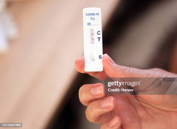 woman shows her positive test for coronavirus - bulgaria coronavirus stock pictures, royalty-free photos & images