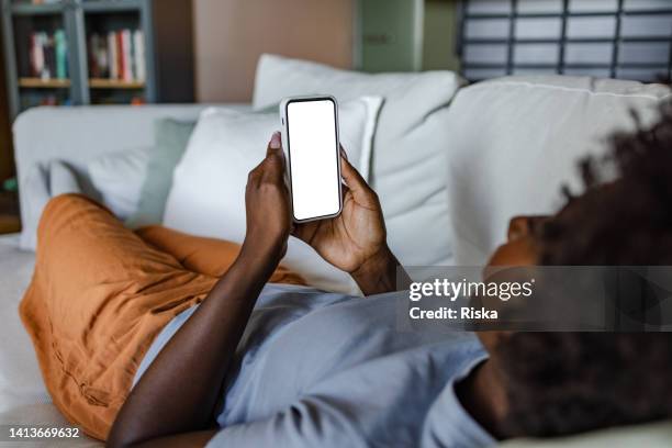 scrolling through the internet content - back of sofa stock pictures, royalty-free photos & images