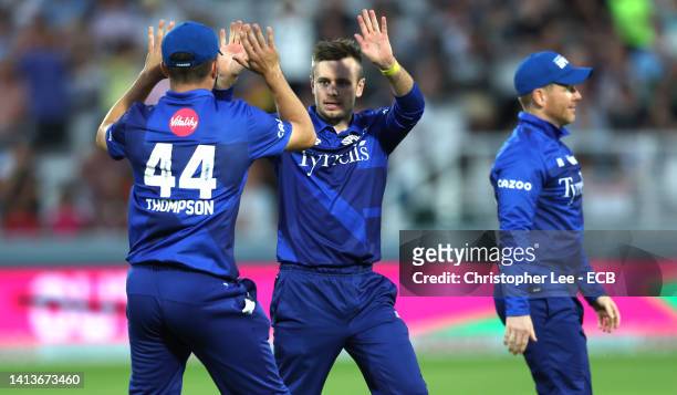 Mason Crane of London Spirit celebrates with Jordan Thompson after he gets Laurie Evans of Manchester Originals out during The Hundred match between...