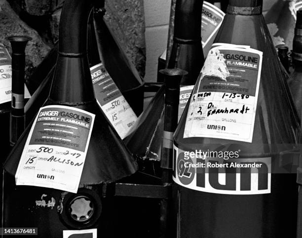 Union 76 racing fuel cans belonging to NASCAR race teams wait to be filled with gas prior to the start of the 1980 Daytona 500 stock car race at...