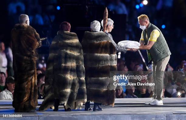 Barrie Lester of Team Australia hands the flag to Her Excellency, the Honourable Linda Dessau AC, Governor of Victoria during the Birmingham 2022...