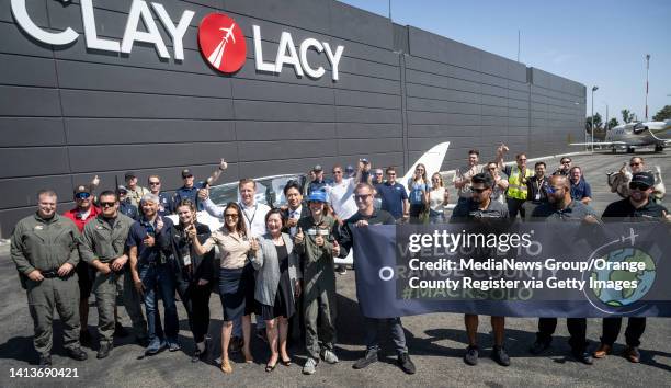 August 08: Seventeen-year-old Mack Rutherford, center in blue hat, takes a photo with county and aviation officials at the private jet terminal Clay...