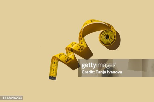 Measuring tapes on beige background Measuring tapes on beige background