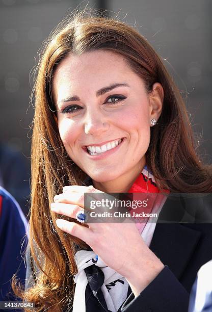 Catherine, Duchess of Cambridge smiles as she wears the Team GB Official Supporter's Scarf for London 2012 before meeting the GB HockeyTeam at the...