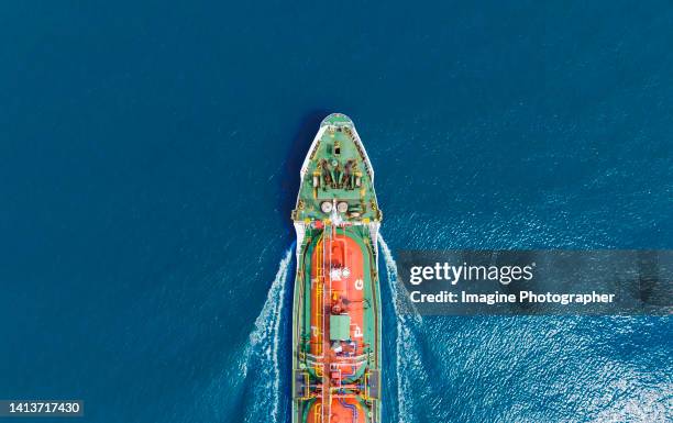 aerial top view, lpg ship tanker are sailing hi-speed and there are beautiful waves in the blue sea. about the import-export business of energy and oil. - nautical vessel part stock pictures, royalty-free photos & images