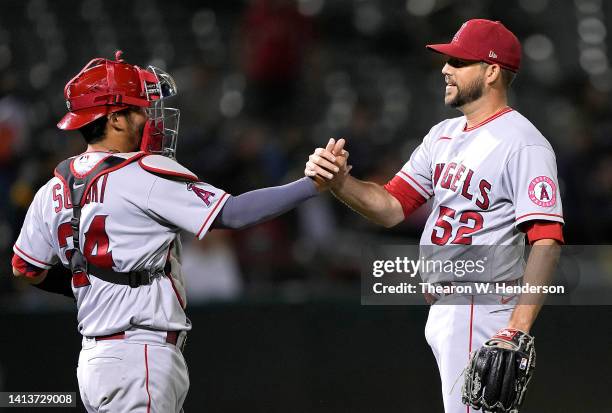 Kurt Suzuki and Ryan Tepera of the Los Angeles Angels celebrate defeating the Oakland Athletics 1-0 at RingCentral Coliseum on August 08, 2022 in...