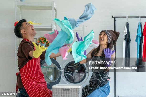 young couple laundry. - husband cleaning stock pictures, royalty-free photos & images