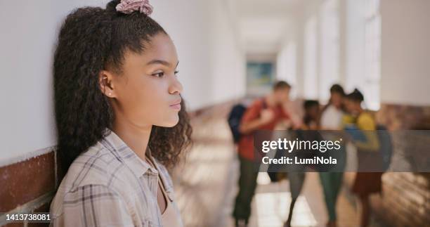 young sad teenage girl feeling lonely and excluded at school. female outside classroom and thinking about teen problems, bullying or trouble feeling depressed and anxiety. - reclusão imagens e fotografias de stock