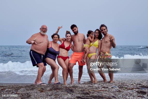 a group of people of various ages taking a fun selfie at the beach - women in bathing suits stock pictures, royalty-free photos & images